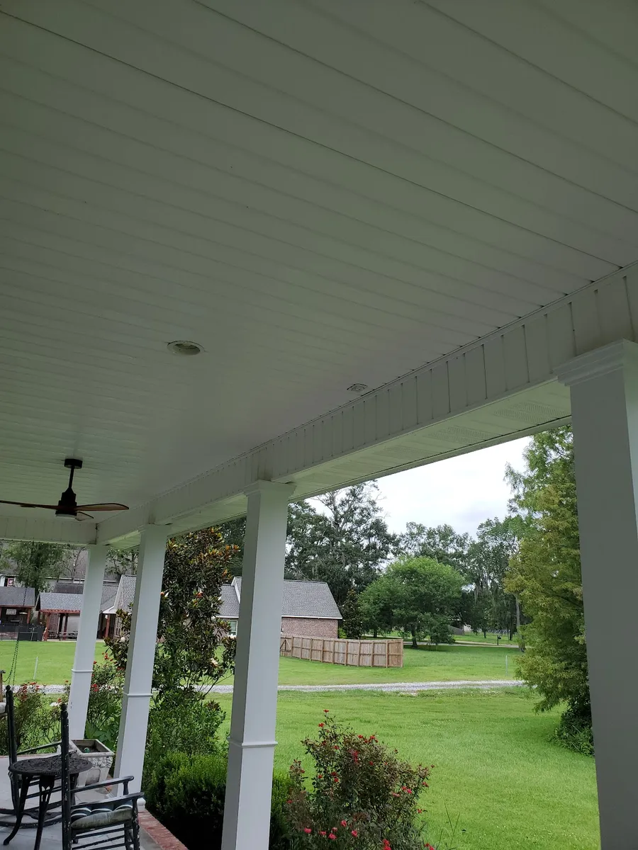 A covered porch with ceiling fans and rocking chairs, cleaned by Delta Exterior Washing. The safe, slip-free porch the review describes