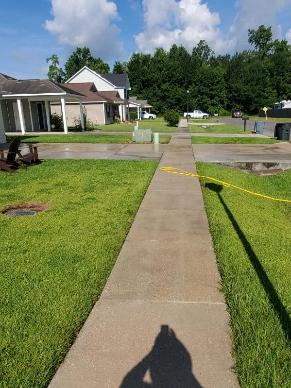 A clean residential sidewalk after washing